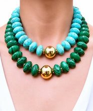 Cargar imagen en el visor de la galería, Close-up of Lena turquoise and green statement necklaces worn at the neck, with gold-tone center beads