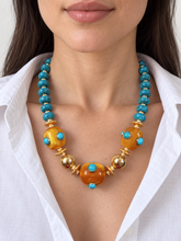 Load image into Gallery viewer, Mar de Miel statement necklace modeled with a white collared shirt