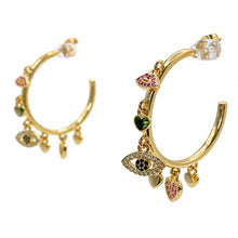 Cargar imagen en el visor de la galería, Charm Karma gold-tone hoop earrings with crystal eye, lip and heart charms on a white background