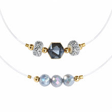Cargar imagen en el visor de la galería, Illusion clear-cord chokers with gray and silver crystal details on a white background