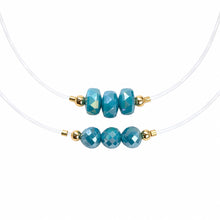 Cargar imagen en el visor de la galería, Two Illusion clear-cord chokers with teal faceted crystal beads on a white background
