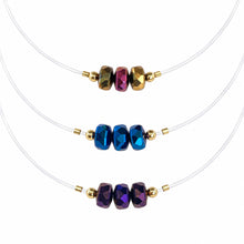 Cargar imagen en el visor de la galería, Illusion clear-cord chokers with bronze, blue and purple faceted crystals on white