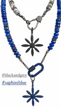 Cargar imagen en el visor de la galería, Bethlehem Star necklaces in black and gray and sapphire blue, with crystal star-flower pendants on white